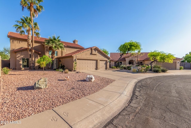 3805 E Desert Flower Ln, Phoenix, AZ 85044 - mediterranean / spanish home featuring a garage, concrete driveway, a tile roof, stucco siding, and a chimney