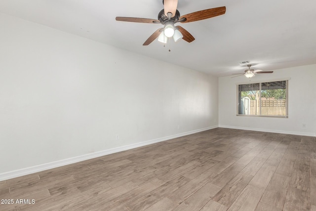 3805 E Desert Flower Ln, Phoenix, AZ 85044 - unfurnished room with light wood-style floors, ceiling fan, and baseboards