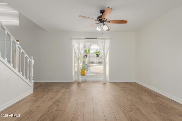 3805 E Desert Flower Ln, Phoenix, AZ 85044 - unfurnished room with stairway, light wood-style flooring, a ceiling fan, and baseboards
