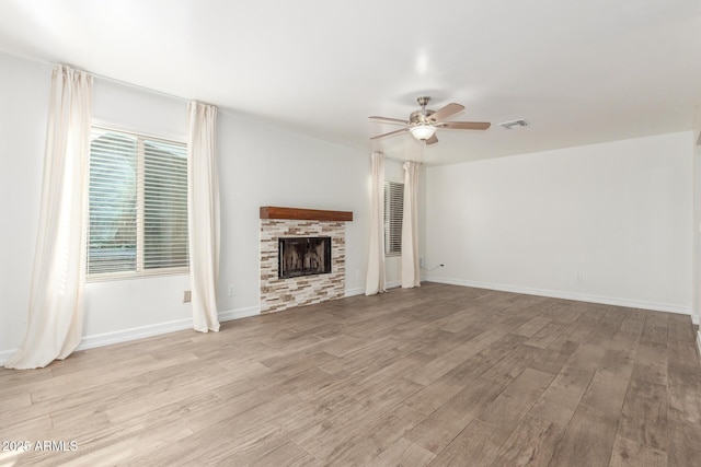 3805 E Desert Flower Ln, Phoenix, AZ 85044 - unfurnished living room featuring ceiling fan, a fireplace, wood finished floors, and baseboards