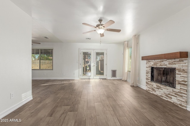 3805 E Desert Flower Ln, Phoenix, AZ 85044 - unfurnished living room featuring ceiling fan, wood finished floors, a fireplace, and baseboards