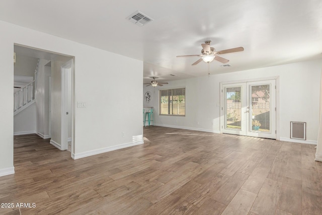 3805 E Desert Flower Ln, Phoenix, AZ 85044 - spare room featuring ceiling fan, light wood-style floors, stairs, and baseboards