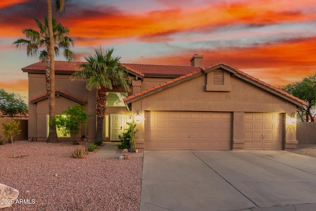 3805 E Desert Flower Ln, Phoenix, AZ 85044 - view of front facade with a garage, driveway, a tiled roof, stucco siding, and a chimney