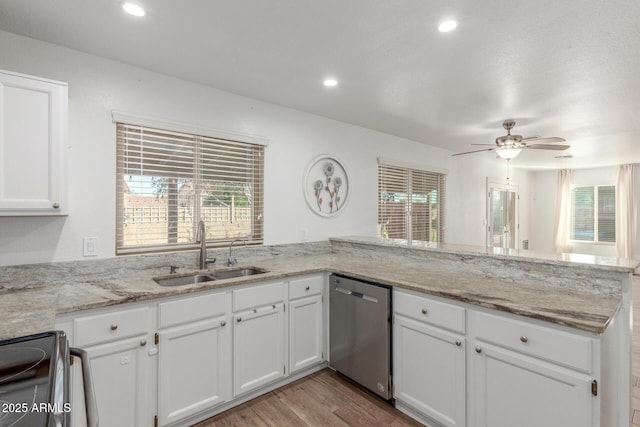 3805 E Desert Flower Ln, Phoenix, AZ 85044 - kitchen with dishwasher, a sink, black range with electric cooktop, a peninsula, and light wood-type flooring
