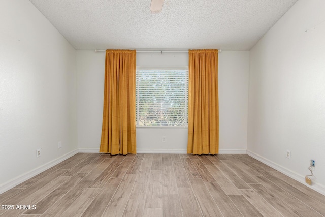 3805 E Desert Flower Ln, Phoenix, AZ 85044 - unfurnished room featuring light wood finished floors, a textured ceiling, and baseboards