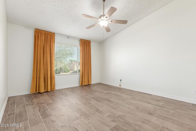 3805 E Desert Flower Ln, Phoenix, AZ 85044 - empty room with a textured ceiling, light wood-type flooring, ceiling fan, vaulted ceiling, and baseboards