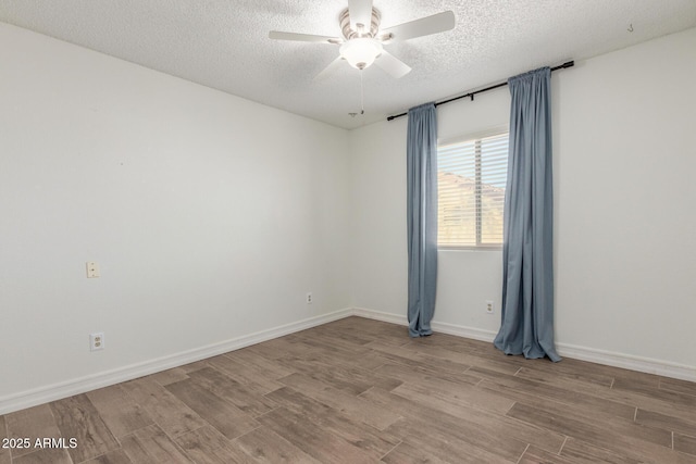 3805 E Desert Flower Ln, Phoenix, AZ 85044 - spare room featuring wood finished floors, a textured ceiling, ceiling fan, and baseboards