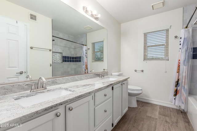3805 E Desert Flower Ln, Phoenix, AZ 85044 - full bathroom with wood finished floors, baseboards, toilet, double vanity, and shower / bath combo with shower curtain