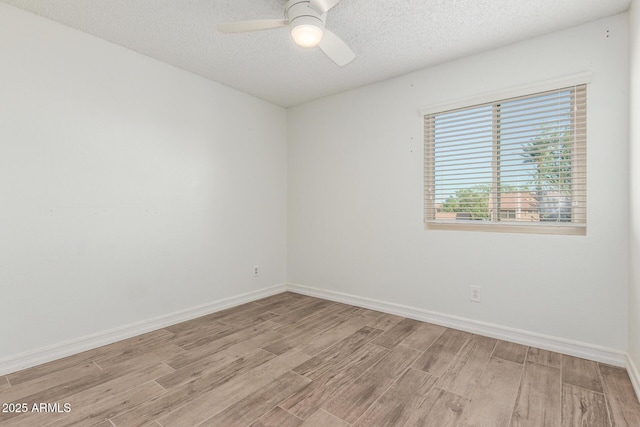 3805 E Desert Flower Ln, Phoenix, AZ 85044 - unfurnished room with light wood-type flooring, ceiling fan, baseboards, and a textured ceiling