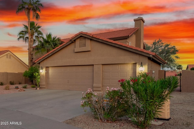 3805 E Desert Flower Ln, Phoenix, AZ 85044 - view of front of house with a garage, stucco siding, driveway, fence, and a chimney