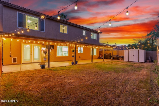3805 E Desert Flower Ln, Phoenix, AZ 85044 - rear view of property featuring a patio area, a storage unit, stucco siding, and an outdoor structure