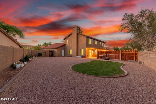 3805 E Desert Flower Ln, Phoenix, AZ 85044 - back of property with a fenced backyard, a patio, stucco siding, and a chimney
