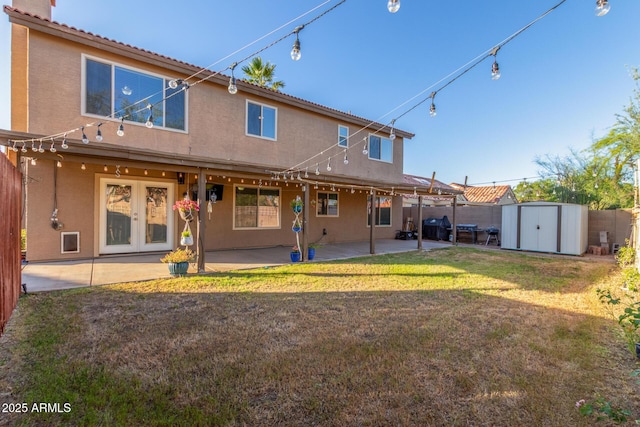 3805 E Desert Flower Ln, Phoenix, AZ 85044 - rear view of house featuring stucco siding, a shed, a patio, and an outbuilding