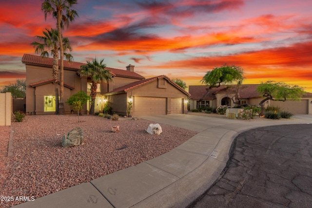 3805 E Desert Flower Ln, Phoenix, AZ 85044 - mediterranean / spanish home featuring a garage, driveway, stucco siding, and a tiled roof
