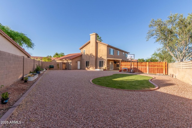 3805 E Desert Flower Ln, Phoenix, AZ 85044 - rear view of property featuring a fenced backyard, a chimney, stucco siding, and a patio area