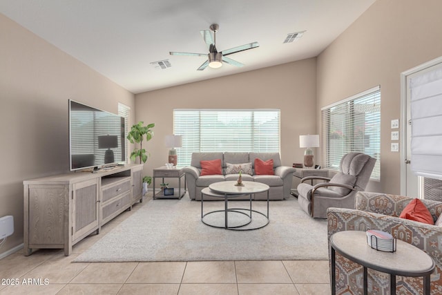 tiled living room with ceiling fan and vaulted ceiling