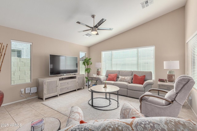 living room with lofted ceiling, ceiling fan, and light tile patterned floors