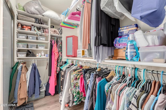 walk in closet featuring light hardwood / wood-style flooring