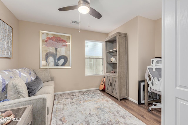 sitting room with ceiling fan and light hardwood / wood-style floors