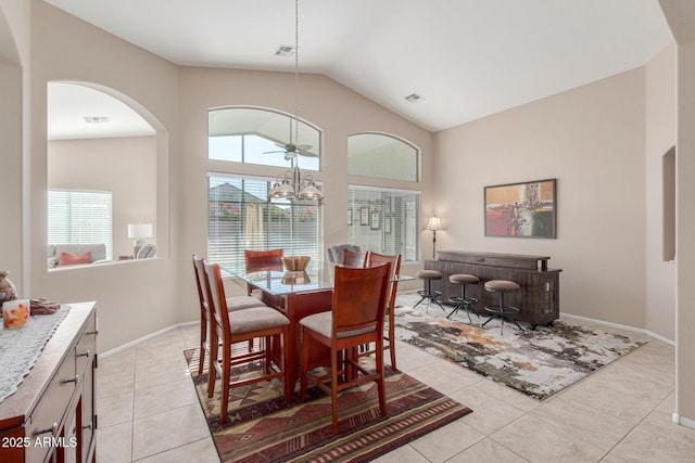 tiled dining room with high vaulted ceiling and ceiling fan