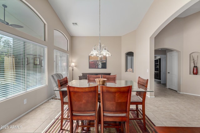 dining room featuring an inviting chandelier, plenty of natural light, and light tile patterned floors