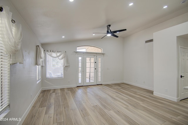 spare room featuring ceiling fan, light hardwood / wood-style floors, and vaulted ceiling