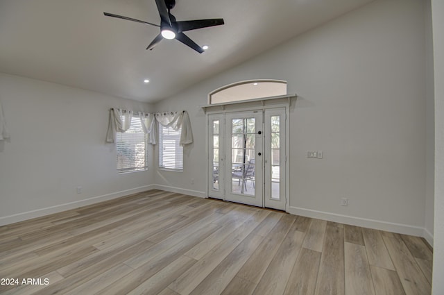 interior space with ceiling fan, light hardwood / wood-style floors, and lofted ceiling