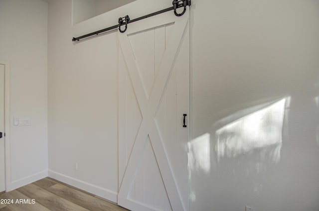 details featuring a barn door and wood-type flooring