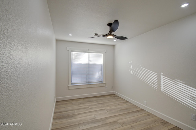 empty room with light hardwood / wood-style floors and ceiling fan