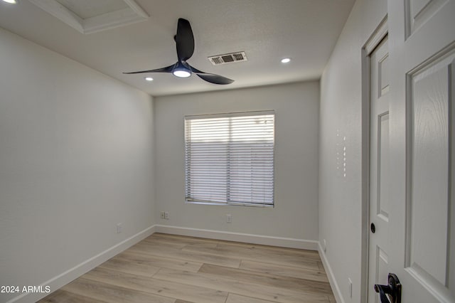 spare room with light hardwood / wood-style flooring and ceiling fan