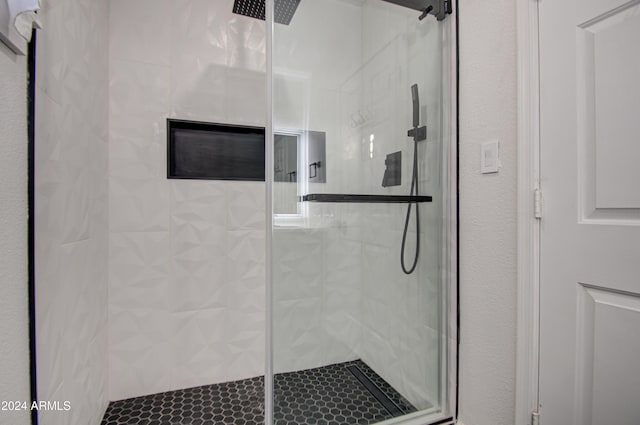 bathroom featuring a shower with shower door