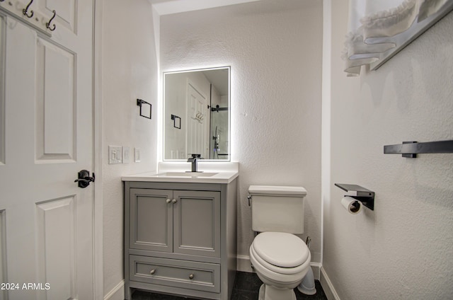 bathroom featuring vanity and toilet