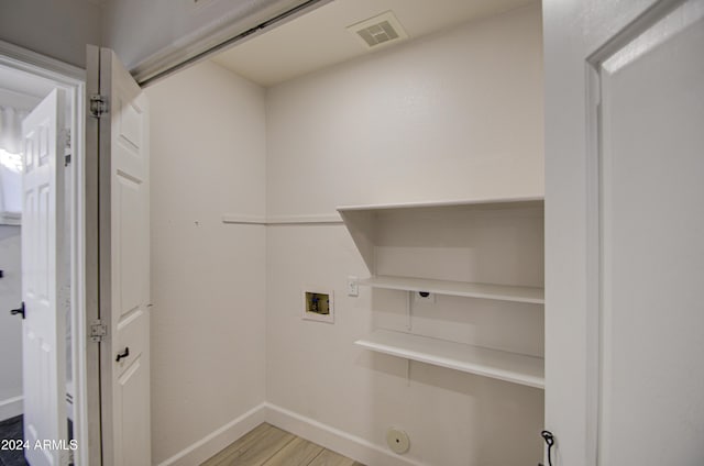 laundry area featuring hookup for a washing machine, light hardwood / wood-style flooring, and gas dryer hookup