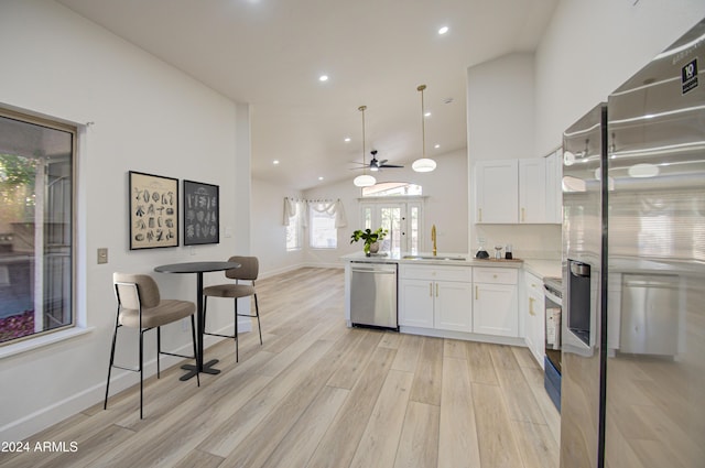 kitchen with sink, white cabinets, stainless steel appliances, and light wood-type flooring