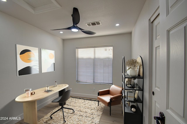 home office with ceiling fan and light hardwood / wood-style flooring