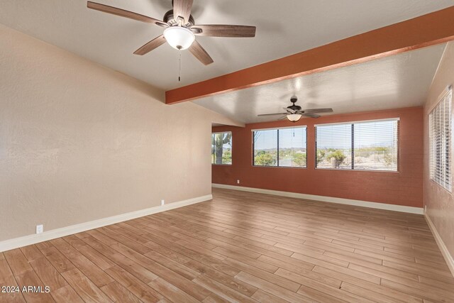 unfurnished room featuring beam ceiling, ceiling fan, and light hardwood / wood-style flooring