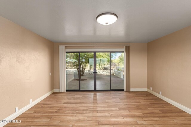 unfurnished room featuring light hardwood / wood-style floors