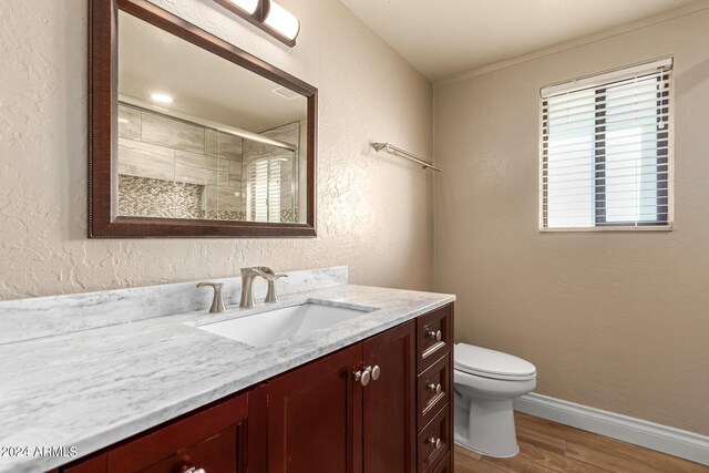 bathroom with an enclosed shower, hardwood / wood-style flooring, vanity, and toilet