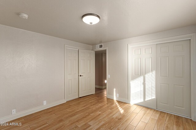 unfurnished bedroom with light hardwood / wood-style flooring