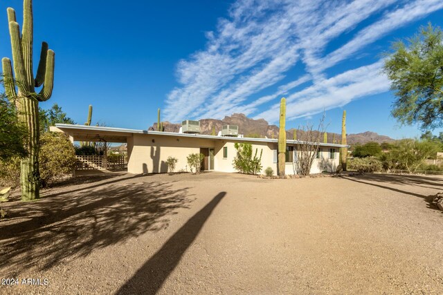 view of front of home featuring a mountain view and a carport