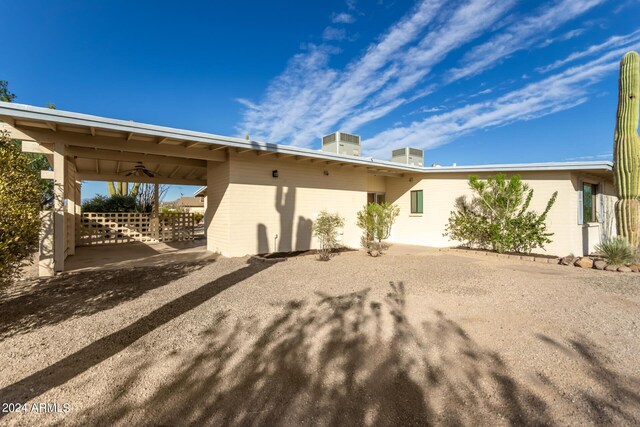 rear view of house featuring central AC unit