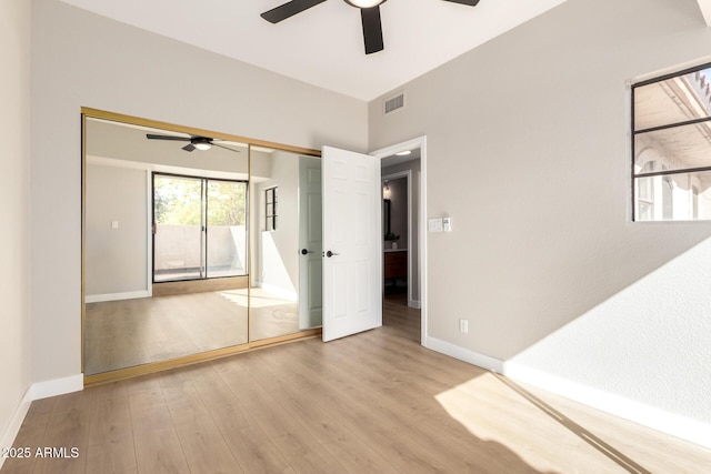 unfurnished bedroom with visible vents, a ceiling fan, baseboards, and wood finished floors