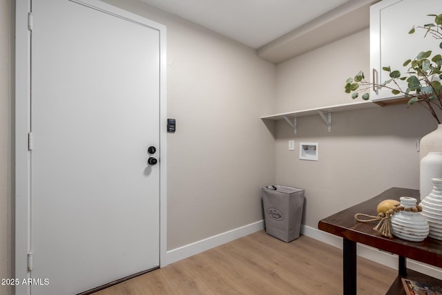 laundry area with baseboards, light wood-style floors, hookup for a washing machine, and laundry area