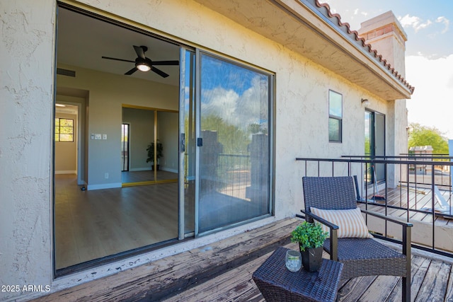 balcony with visible vents and ceiling fan