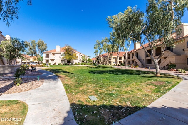 view of home's community with a yard and a residential view