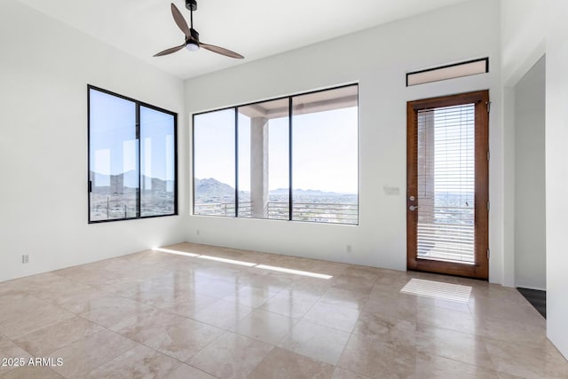 unfurnished room featuring a ceiling fan