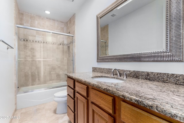 full bathroom featuring shower / bath combination with glass door, visible vents, toilet, vanity, and tile patterned flooring