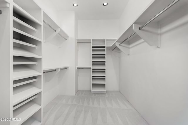 walk in closet with carpet floors