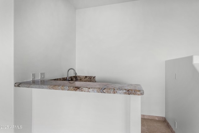 bathroom featuring tile patterned flooring and baseboards