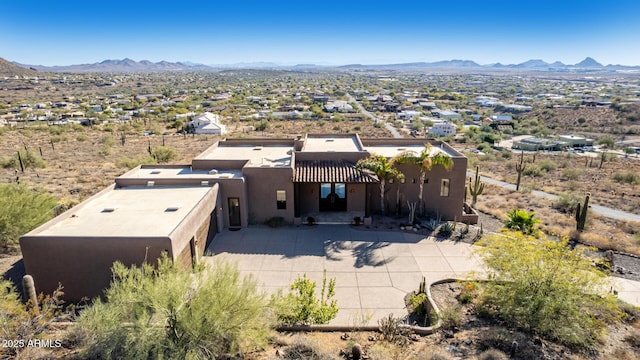 birds eye view of property featuring a mountain view